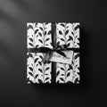 Elegant floral gift wrap with black satin ribbon and "With Love" tag.