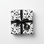 Wrapped gift with black ribbon and floral wrapping paper from Wrapped Studios.
