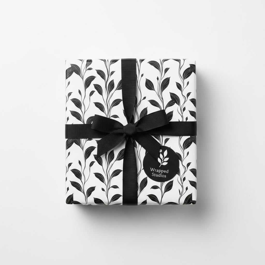 Wrapped gift with black ribbon and floral wrapping paper from Wrapped Studios.