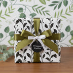 Modern floral wrapping paper with olive green ribbon. Wrapped Studios.