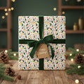 Festive Christmas gift with floral wrapping paper, green velvet ribbon, and "Happy Holidays!" tag.