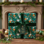 Elegant Christmas gift wrapped in green floral wrapping paper with a velvet ribbon and "Holiday Cheer" tag.