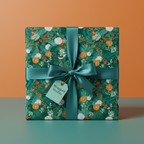 Square gift box in festive green floral wrapping paper with teal satin ribbon and bow.