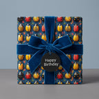 Bug pattern birthday wrapping paper with a luxurious blue velvet ribbon.