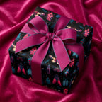 Gift wrapped in black paper with colorful beetle illustrations and bright pink ribbon.