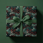 Dark floral Christmas gift wrap with a green ribbon and bow.