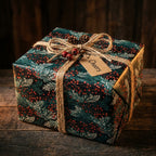 Elegant Christmas gift wrap with floral botanical pattern, tied with twine and a "Cheers" tag.