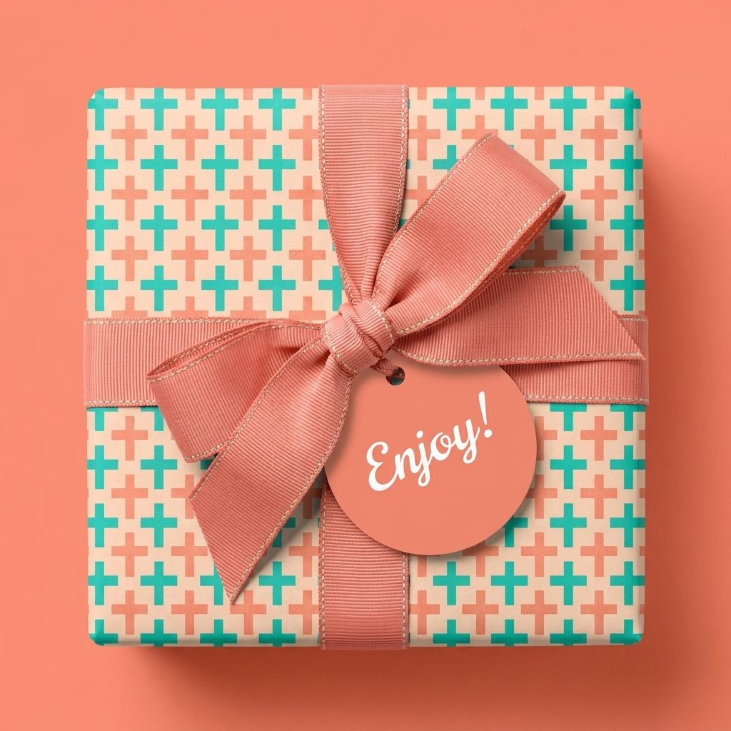 Modern geometric gift wrap with teal and coral plus pattern and pink ribbon bow by Wrapped Studios.