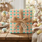 Pastel Easter wrapping paper with a teal and peach plus pattern and raffia bow by Wrapped Studios.