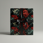 Elegant floral wrapping paper featuring red blossoms and a black satin ribbon.