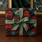 Elegant gift wrapped in floral wrapping paper with red flowers and green ribbon on dark background.