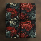 Elegant gift box wrapped in dark floral wrapping paper with red, grey and white flowers and black string.