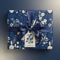Dark blue floral wrapping paper with a satin ribbon and a gift tag that reads "A Gift for You."