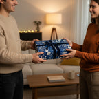 Couple exchanging a gift wrapped in elegant blue floral wrapping paper with a navy velvet ribbon.