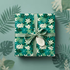 Teal floral wrapping paper on square gift with matching ribbon and leafy tag.
