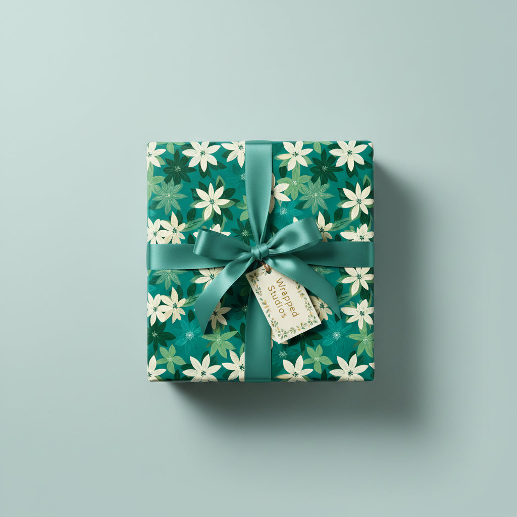 Wrapped gift with a green floral wrapping paper, tied with matching ribbon and branded tag.