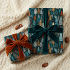 Elegant presents wrapped in forest tree print wrapping paper with velvet ribbon on a knit blanket.