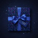 Navy blue gift with modern geometric wrapping paper, satin bow, and tag on starry background.