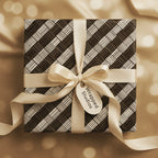 Elegant gift wrapped in modern geometric wrapping paper with a satin ribbon and bow.