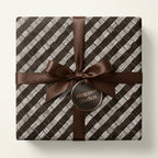 Elegant gift box wrapped in modern geometric patterned paper with a chocolate brown satin ribbon and bow.