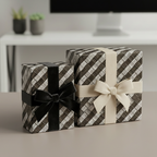 Modern gift boxes wrapped in woven pattern gift wrap with velvet and grosgrain ribbon bows.