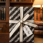 Elegant gift wrapped in modern black and white woven wrapping paper with an ivory ribbon and "For You" tag.