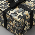 Modern gift wrapped in black and beige geometric wrapping paper with a black ribbon bow.