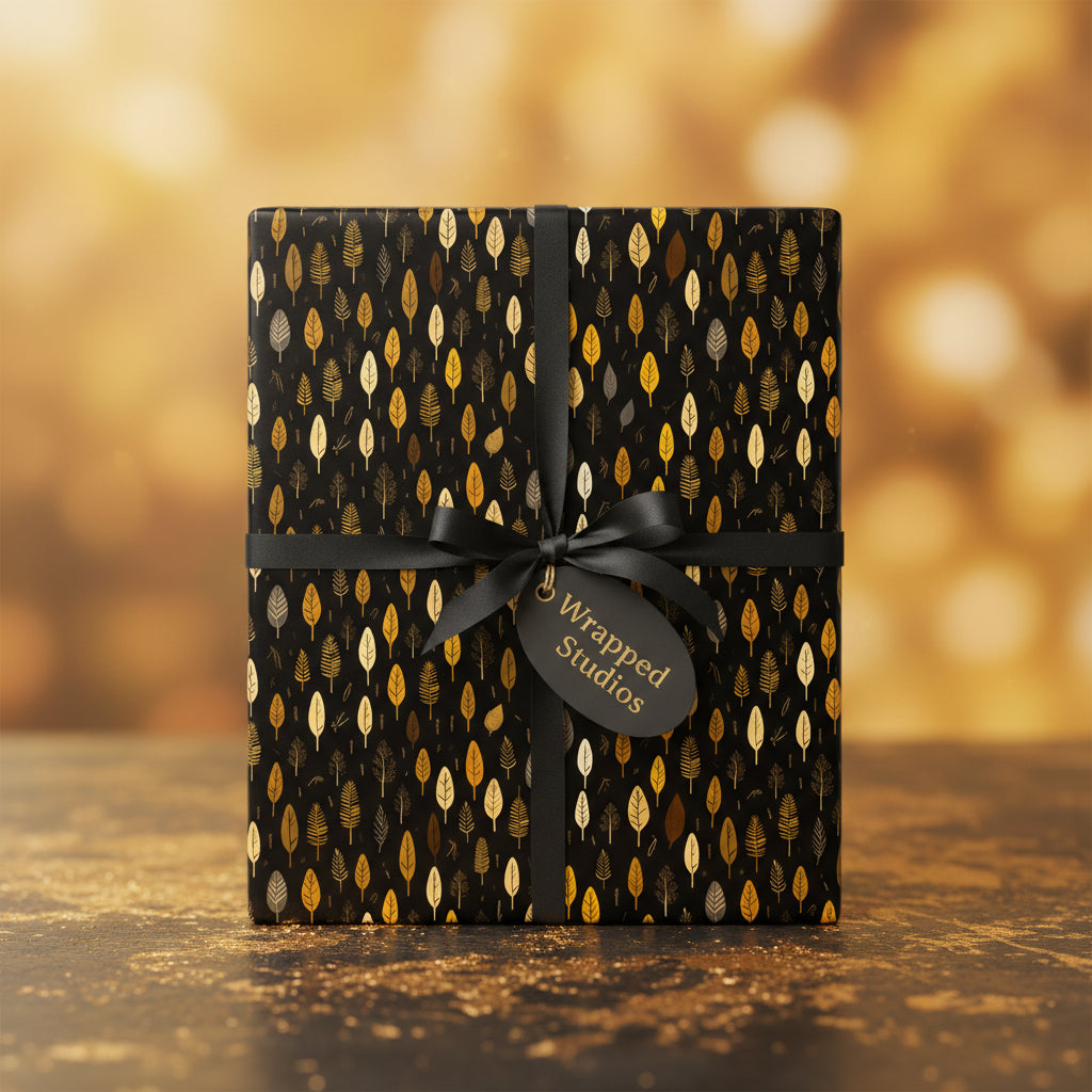 Luxury gift wrap with gold leaf pattern and black ribbon; elegant birthday wrapping paper.