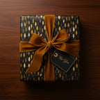 Elegant gift wrapped in black floral wrapping paper with gold accents and a velvet gold ribbon.
