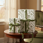 Elegant gifts wrapped in floral wrapping paper with green velvet ribbon on a dark wood table.