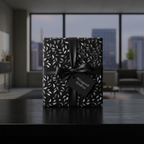Elegant black and silver leaf pattern wrapping paper with satin ribbon and gift tag.
