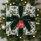 Elegant Christmas gift with festive floral wrapping paper, velvet bow, and "Joy" tag.