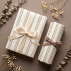 Elegant neutral striped wrapping paper with satin and velvet bows by Wrapped Studios.