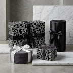 Modern black and white pattern wrapping paper and luxury gift wrap on boxes by Wrapped Studios.