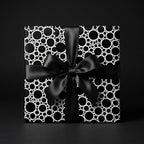 Modern black and white polka dot wrapping paper with a luxury satin bow, by Wrapped Studios.