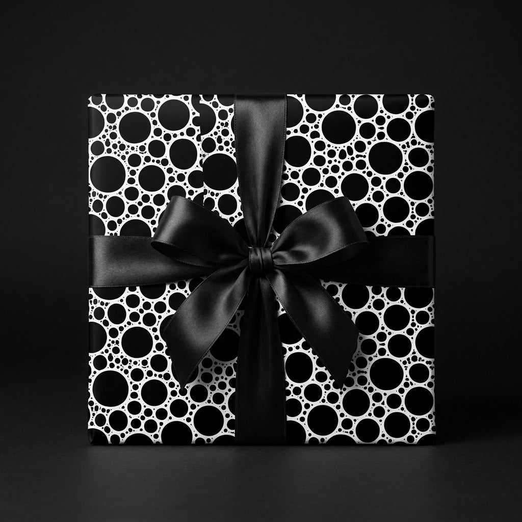 Modern black and white polka dot wrapping paper with a luxury satin bow, by Wrapped Studios.