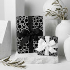 Modern black and white wrapping paper with circle pattern on luxury gifts by Wrapped Studios.