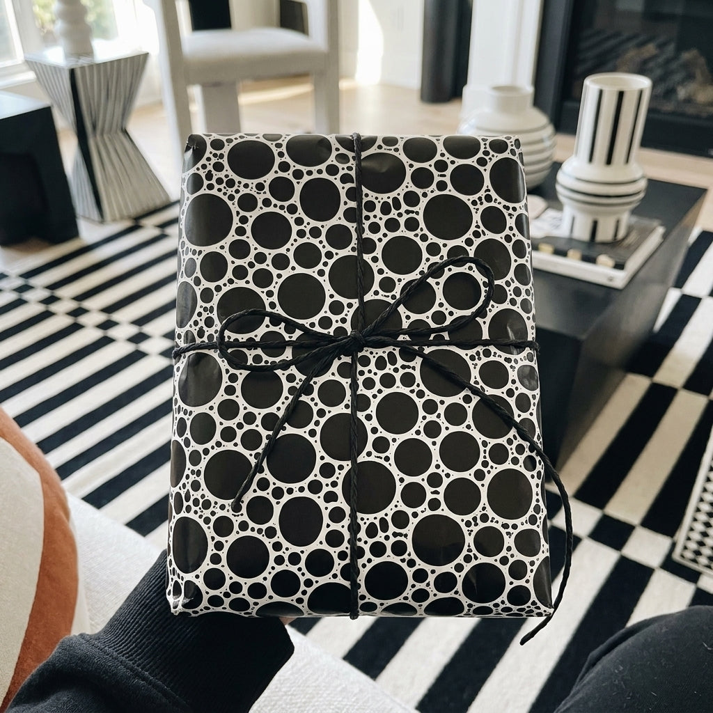Modern black and white wrapping paper with a bubble pattern and twine bow by Wrapped Studios.