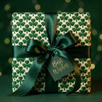Shamrock wrapping paper with a dark green satin bow and Best Wishes tag by Wrapped Studios.