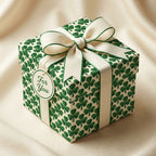 St. Patrick's Day clover wrapping paper on a gift box with cream bow by Wrapped Studios.