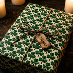 Irish shamrock wrapping paper with a twine bow and Sláinte tag by Wrapped Studios.