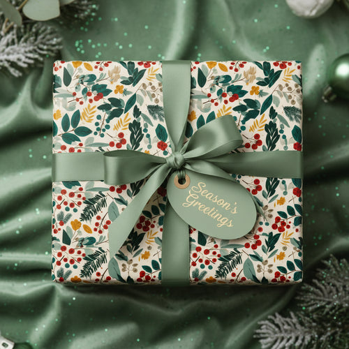 Elegant Christmas gift wrap with floral pattern, sage ribbon, and "Season's Greetings" tag.