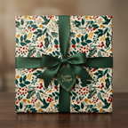 Square gift wrapped in floral Christmas wrapping paper with dark green satin ribbon and "Winter's Delight" tag.
