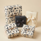 Travel wrapping paper featuring world landmarks and airplanes on elegant gift boxes by Wrapped Studios.