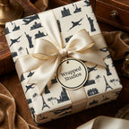 Luxury travel wrapping paper with world landmarks and cream bow by Wrapped Studios.
