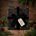 Luxury dark floral Christmas wrapping paper with a black velvet bow and tag by Wrapped Studios.