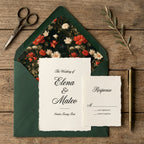 Moody floral wedding invitation with dark green envelope liner and response card by Wrapped Studios.