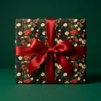 Luxury floral wrapping paper with a vintage poppy pattern and large red satin bow by Wrapped Studios.