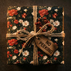 Vintage floral wrapping paper with red poppies, twine bow, and No Peeking tag by Wrapped Studios.