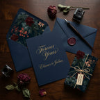 Moody floral wrapping paper on a small gift box with luxury wedding stationery by Wrapped Studios.